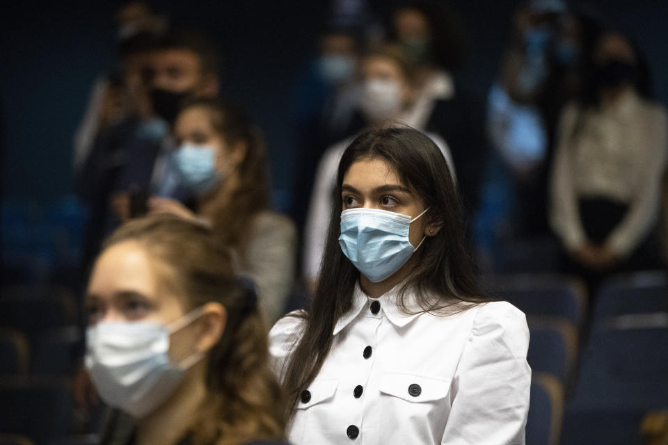 Students of the MGIMO (Moscow State Institute for Foreign Relations) wearing face masks to protect against coronavirus attend a meeting with Russian Foreign Minister Sergey Lavrov in Moscow, Russia, Tuesday, Sept. 1, 2020. Russia's tally of confirmed coronavirus cases has surpassed 1 million after authorities reported 4,729 new cases. With a total of 1,000,048 reported cases up to Tuesday, Russia has the fourth largest caseload in the world after the U.S., Brazil and India. (AP Photo/Pavel Golovkin)