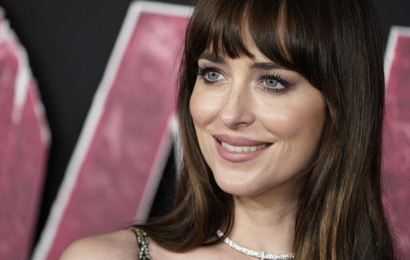 Dakota Johnson, up-close, smiles for cameras at "Madame Web" premiere