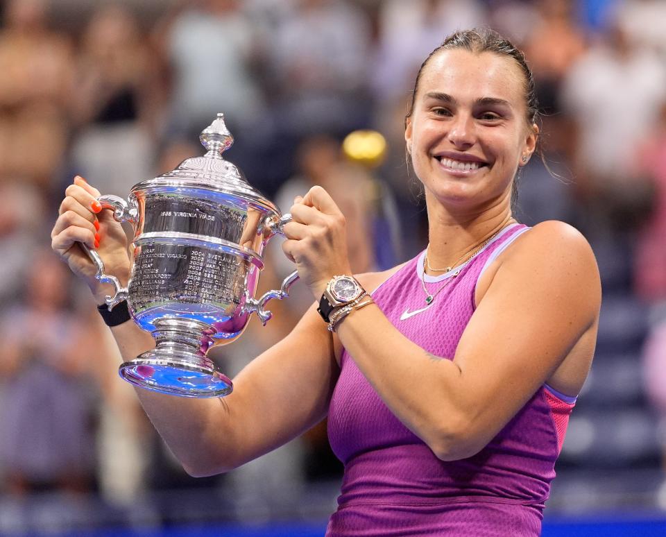 Aryna Sabalenka holds up the US Open Trophy after beating Jessica Pegula in the women's singles final.