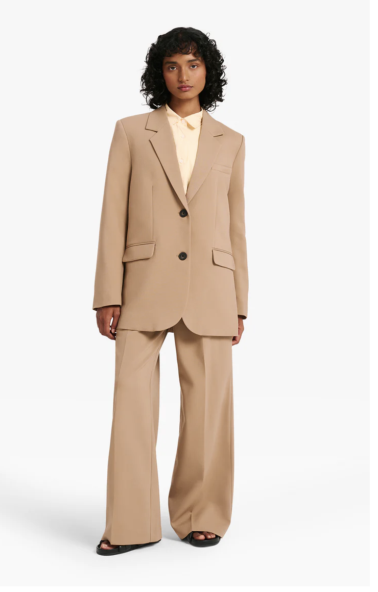 Model in camel coloured blazer and trousers