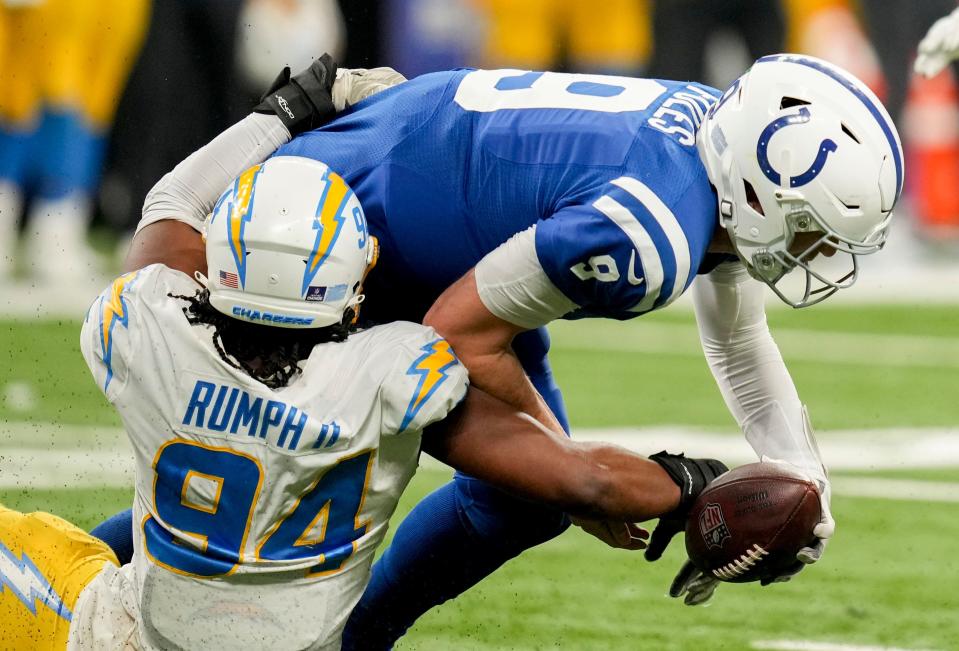 Indianapolis Colts quarterback Nick Foles (9) is brought down by Los Angeles Chargers linebacker Chris Rumph II (94) on Monday, Dec. 26, 2022, during a game against the Los Angeles Chargers at Lucas Oil Stadium in Indianapolis.