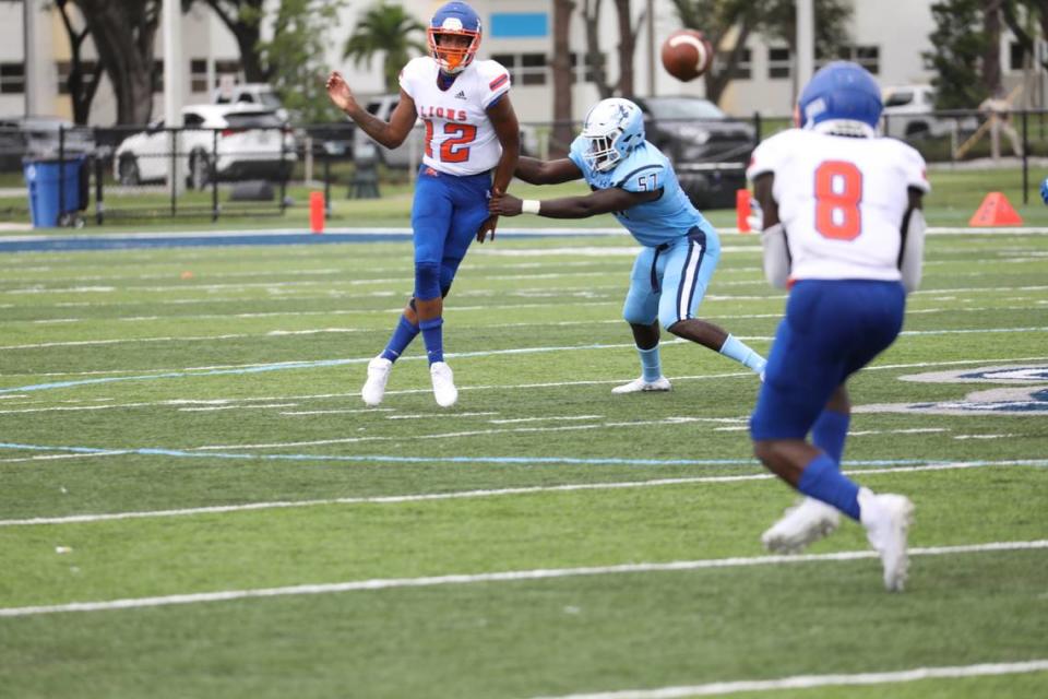 Florida Memorial sophomore quarterback Antoine Williams evades a Keiser defender while attempting to pass to freshman running back George Young.