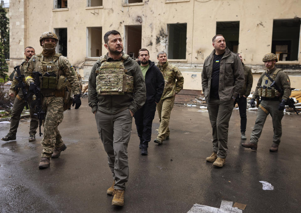 In this photo provided by the Ukrainian Presidential Press Office on Sunday, May 29, 2022, Ukrainian President Volodymyr Zelenskyy walks with his stuff as he visits the war-hit Kharkiv region. Volodymyr Zelenskyy described the situation in the east as 