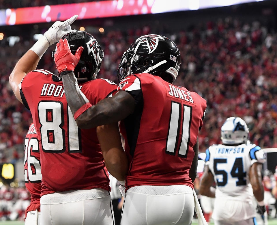 Atlanta Falcons tight end Austin Hooper (81) celebrates his touchdown with Atlanta Falcons wide receiver Julio Jones (11) against the Carolina Panthers during the first half of an NFL football game, Sunday, Sept. 16, 2018, in Atlanta. (AP Photo/John Amis)