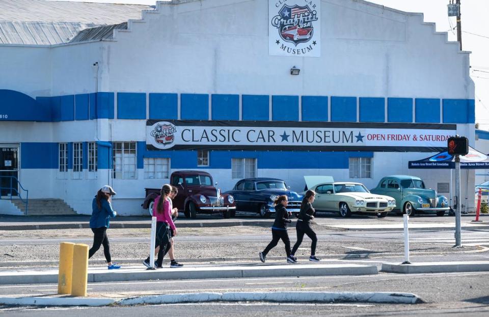 Runners pass the Graffti USA Classic Car Museum as they head toward the finish line during the Modesto Marathon in Modesto, Calif., Sunday, March 26, 2023.