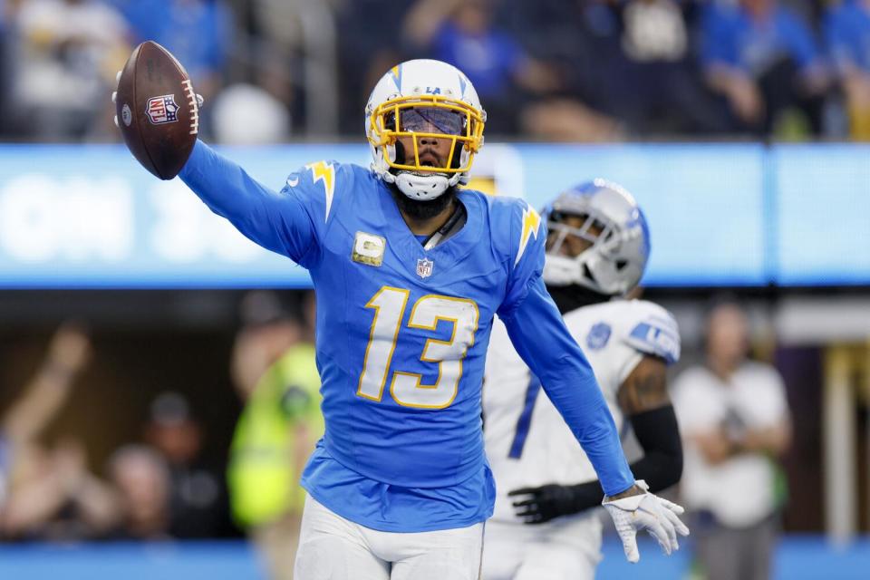 Chargers wide receiver Keenan Allen holds the ball aloft after scoring a touchdown against the Raiders last season.