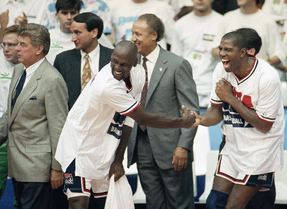 FILE - In this Aug. 8, 1992, file photo, USA's Earvin "Magic" Johnson, right, and Michael Jordan shake hands near the end of their 117-85 win over Croatia in the gold medal game in men's basketball at the Summer Olympics in Barcelona, as head coach Chuck Daly, left, and his assistant coaches Mike Krzyzewski, second left, and Lenny Wilkens, center, look on (AP Photo/John Gaps III, FIle)