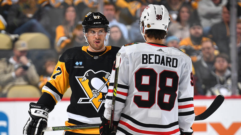 Sidney Crosby of the Pittsburgh Penguins and Connor Bedard of the Chicago Blackhawks prepare for a faceoff. (Photo by Joe Sargent/NHLI via Getty Images)