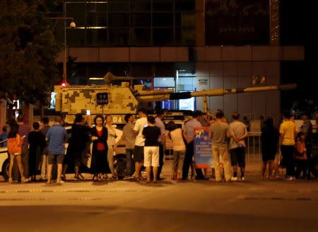 Residents look around a tank which is parked for the upcoming military parade to mark the 70th Anniversary of the end of World War Two, in Beijing, China, September 2, 2015.REUTERS/Kim Kyung-Hoon