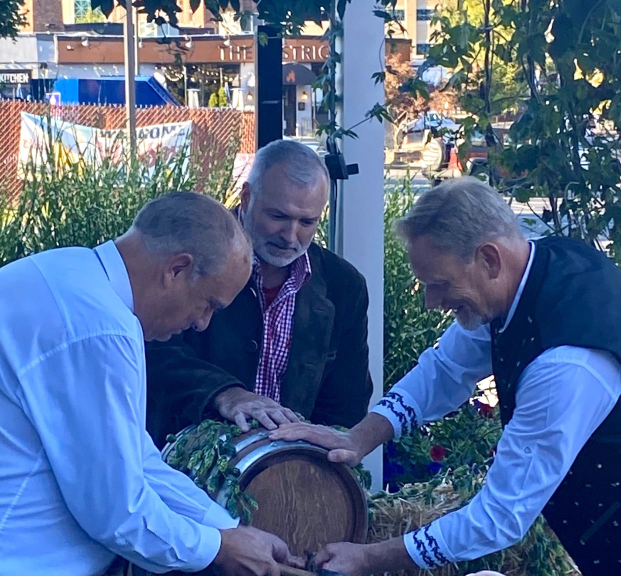 Worcester Mayor Joseph Petty joins Bay State Brewing Co.'s Chip Jarry in the ceremonial keg tapping, kicking off the brewery's Oktoberfest celebrations.