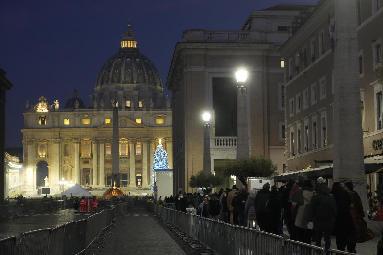 CORRECTS DATE TO JAN. 4 - Faithful arrive at dawn to view the body of Pope Emeritus Benedict XVI as it lies in state in St. Peter's Basilica at the Vatican, Wednesday, Jan. 4, 2023. The Vatican announced that Pope Benedict died on Dec. 31, 2022, aged 95, and that his funeral will be held on Thursday, Jan. 5, 2023. (AP Photo/Gregorio Borgia)