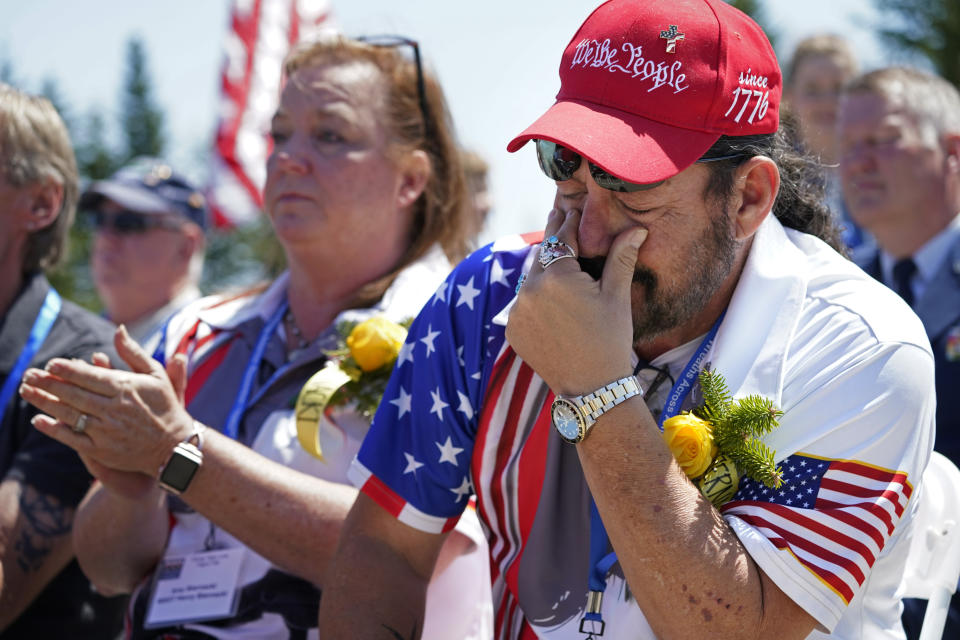 John Biernacki of Greenville, Tex., wipes tears during the unveiling of a monument to honor the military passengers of Flying Tiger Line Flight 739, Saturday, May 15, 2021, in Columbia Falls, Maine. His father, MSgt., Henry Biernacki, was among those killed on the secret mission to Vietnam in 1962. (AP Photo/Robert F. Bukaty)