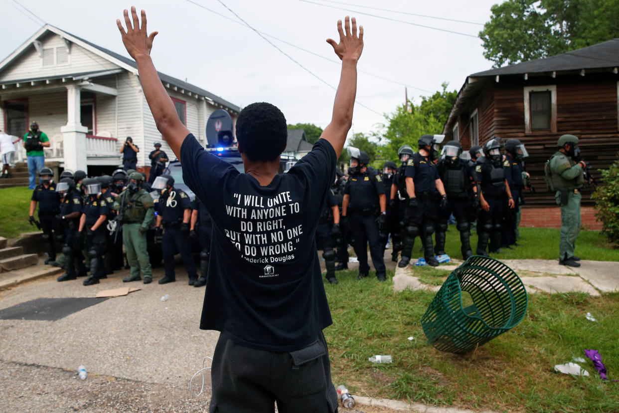 A demonstrator raises his hands in front of police in riot gear during protests in Baton Rouge, Louisiana, U.S., July 10, 2016.  REUTERS/Shannon Stapleton     TPX IMAGES OF THE DAY     