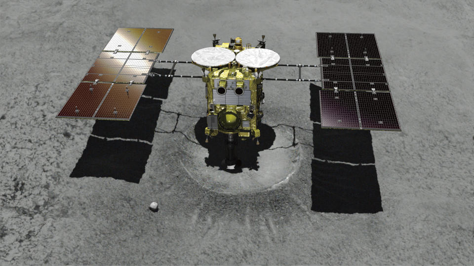 This computer graphic image provided by the Japan Aerospace Exploration Agency (JAXA) shows the Japanese unmanned spacecraft Hayabusa2 approaching on the asteroid Ryugu. Japan’s space agency is delaying a spacecraft touchdown on an asteroid as scientists need more time to find a safe landing site on the extremely rocky surface. (JAXA via AP)