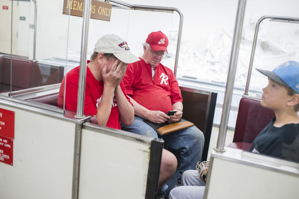 Rep. Joe Barton&nbsp;(R-Texas), center, and his sons board the Rayburn subway in the basement of the Capitol after the shooting. (Photo: Tom Williams via Getty Images)