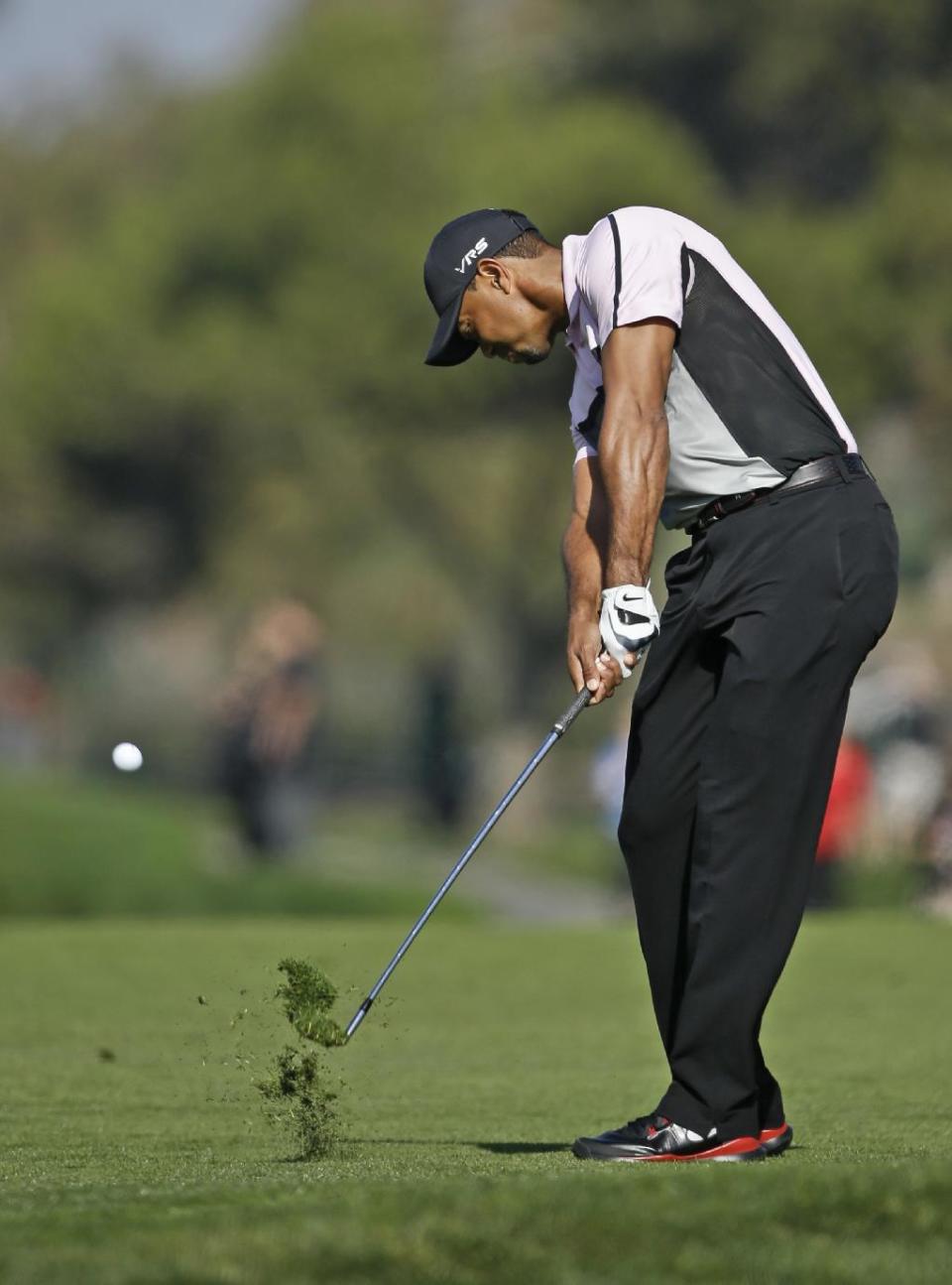 Tiger Woods hits to the second green on the south course at Torrey Pines during the first round of the Farmers Insurance Open golf tournament Thursday, Jan. 23, 2014, in San Diego. (AP Photo/Lenny Ignelzi)