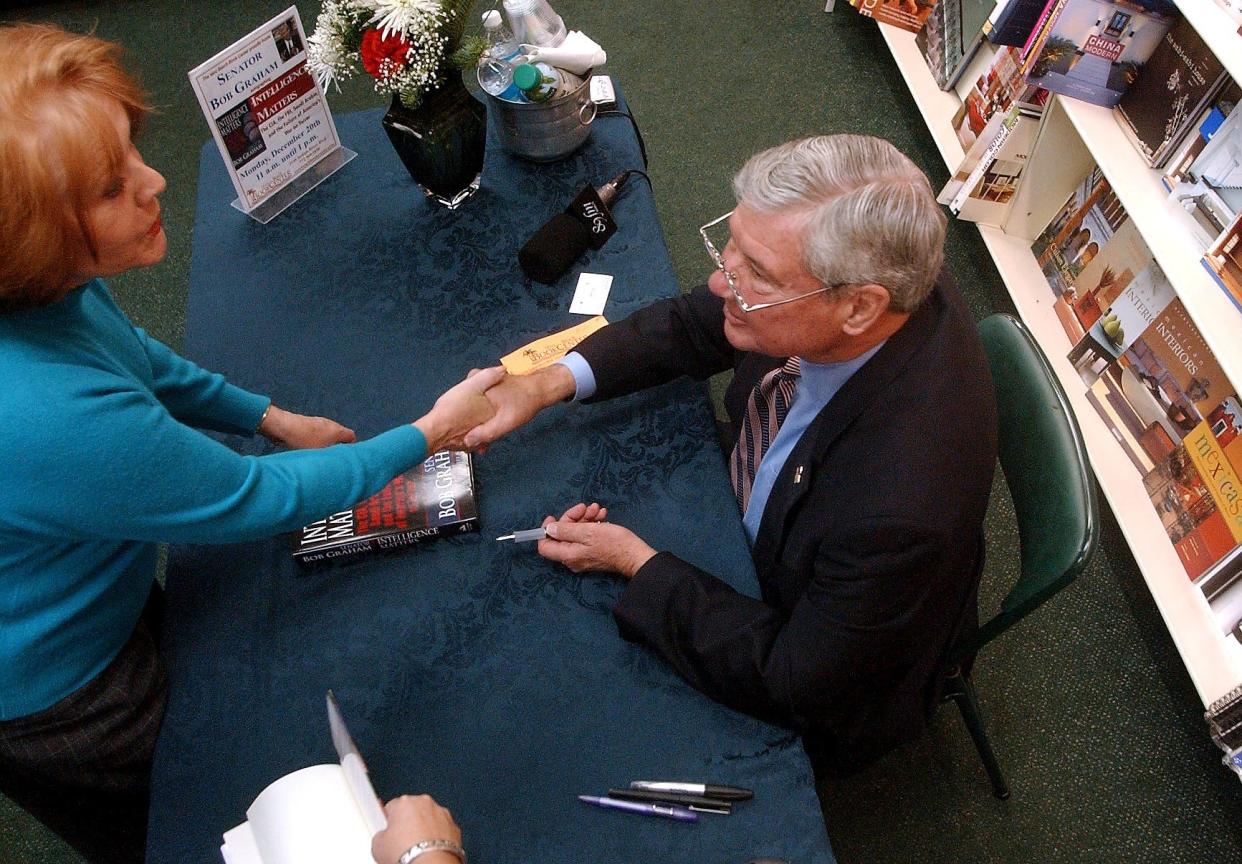 Patricia Miller, of Vero Beach, shakes Sen. Bob Graham's hand after he signs her copy of his newly published book, "Intelligence matters: The CIA, the FBI, Saudi Arabia and the Failure of America's War on Terror," Dec. 21, 2004, at the Vero Beach Book Center. Graham, the former governor of Florida, has traveled the state to talk to people about his new book.