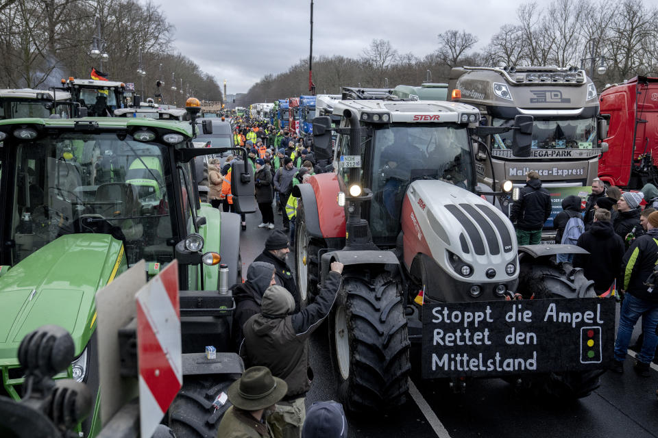 Farmers with tractors arrive for a protest at the government district in Berlin, Germany, Jan 15, 2024. This week began and ended with the long road in front of Berlin’s landmark Brandenburg Gate thronged by heavy vehicles tooting their horns in protest — farmers on Monday Jan. 15 and truckers on Friday Jan. 19, 2024. Such demonstrations underline deep frustration in Germany with Chancellor Olaf Scholz’s government, which came to power just over two years ago with a progressive, modernizing agenda but has come to be viewed by many as dysfunctional and incapable. (AP Photo/Ebrahim Noroozi, File)