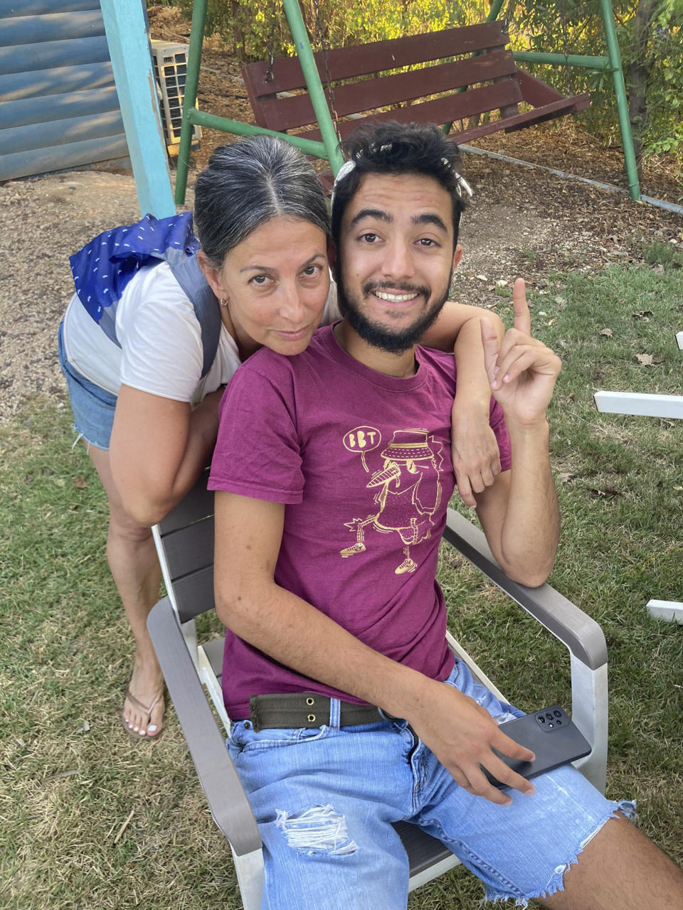 This undated photo provided by Rachel Goldberg shows her with her son Hersh Goldberg-Polin. The 23-year-old from Jerusalem was last seen when Hamas militants loaded him into the back of a pickup truck with other hostages abducted from a music festival in the western Negev Desert on Oct. 7. (Courtesy of Rachel Goldberg via AP)