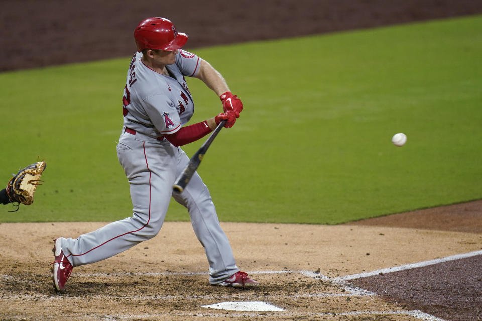 Los Angeles Angels' Max Stassi hits a two-run home run during the sixth inning of the team's baseball game against the San Diego Padres, Tuesday, Sept. 22, 2020, in San Diego. (AP Photo/Gregory Bull)