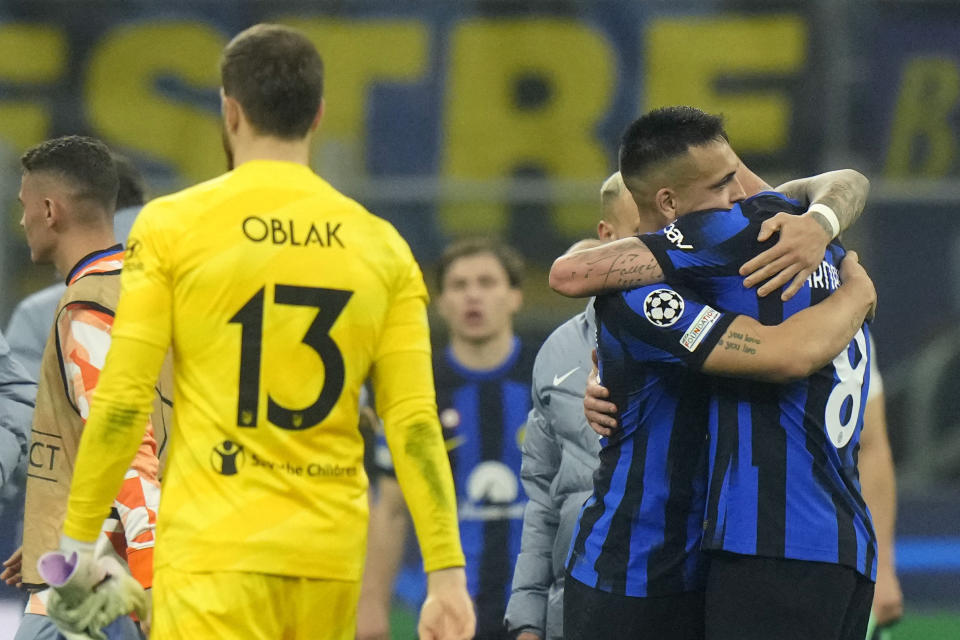 Inter Milan's Lautaro Martinez embraces Inter Milan's Marko Arnautovic after the Champions League, round of 16, first leg soccer match between Inter Milan and Atletico Madrid, at the San Siro stadium in Milan, Italy, Tuesday, Feb. 20, 2024. (AP Photo/Luca Bruno)