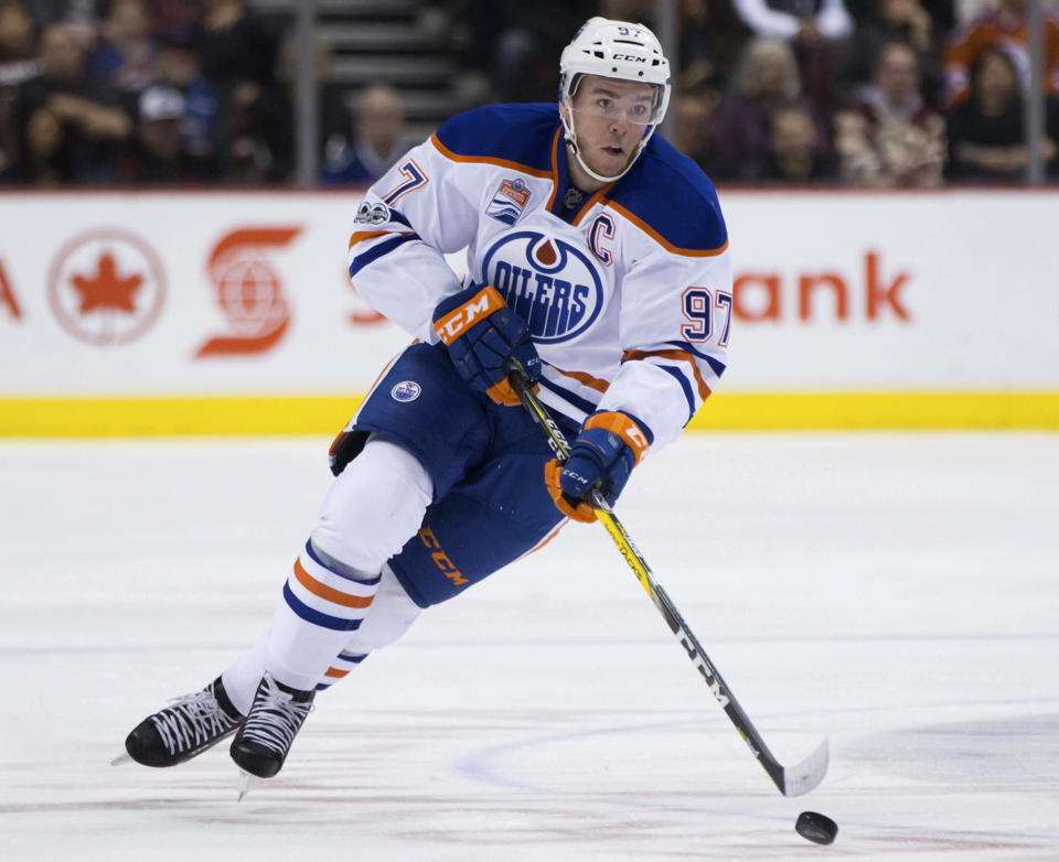 Edmonton Oilers' Connor McDavid skates with the puck against the Vancouver Canucks during the first period of an NHL hockey game Saturday, April 8, 2017, in Vancouver, British Columbia. (Darryl Dyck/The Canadian Press via AP)