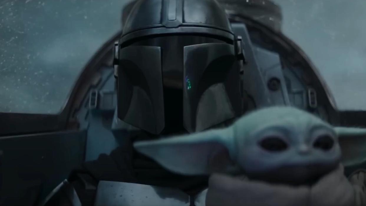  The Mandalorian piloting starship with Grogu on his lap 