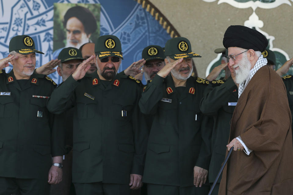 FILE - In this May 20, 2015 file photo, released by an official website of the office of the Iranian supreme leader, Gen. Hossein Salami, second right, salutes as Supreme Leader Ayatollah Ali Khamenei, right, arrives at a graduation ceremony of the Revolutionary Guard's officers in Tehran, Iran. Iran's supreme leader has appointed Salami to head to the country's powerful Revolutionary Guard, just after the U.S. designated the paramilitary force a terrorist group. Former commanders of the Revolutionary Guard Mohsen Rezaei, second left, and Yahya Rahim Safavi salute. (Office of the Iranian Supreme Leader via AP, File)