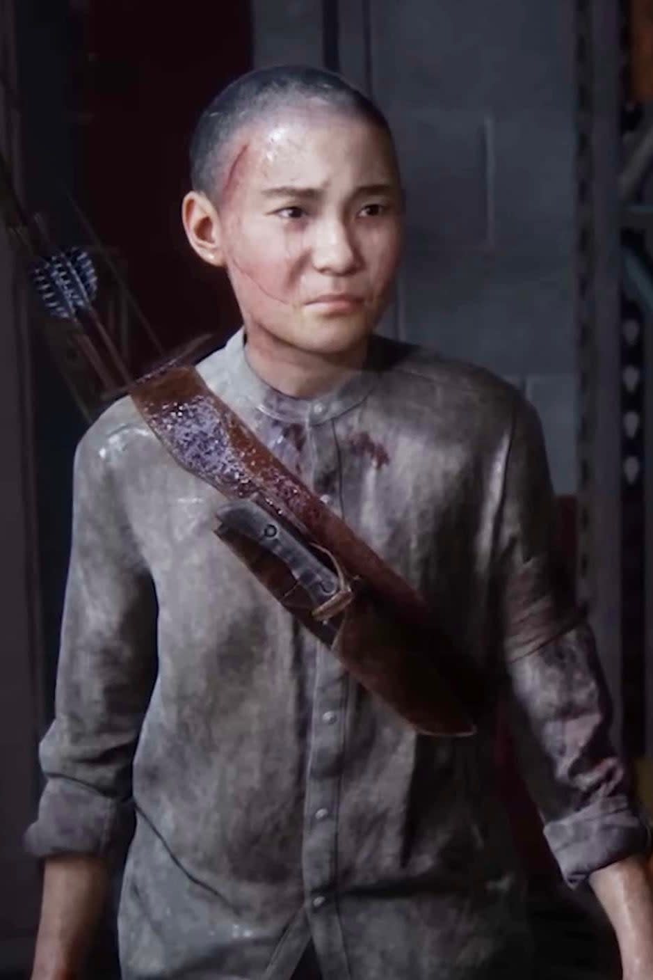 Lev in The Last of Us Part II video game, with a backpack strap, looking intently forward