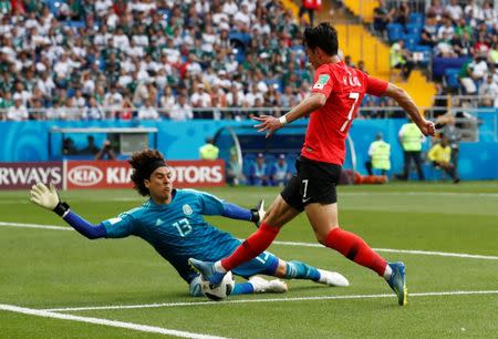 Soccer Football - World Cup - Group F - South Korea vs Mexico - Rostov Arena, Rostov-on-Don, Russia - June 23, 2018 South Korea's Son Heung-min in action with Mexico's Guillermo Ochoa REUTERS/Damir Sagolj