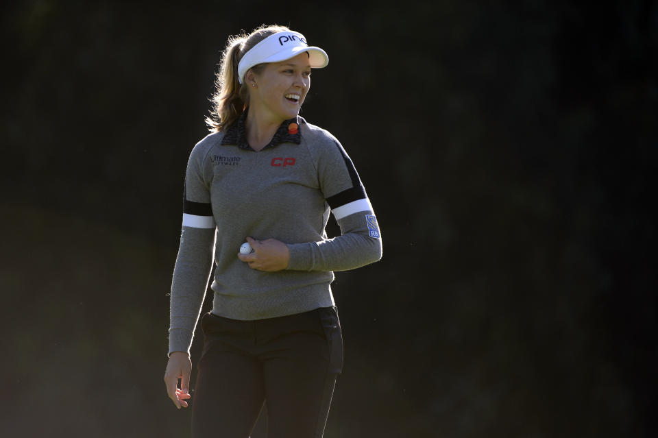 Brooke M. Henderson, of Canada, smiles after a putt on the 12th green during the first round of the Kia Classic LPGA golf tournament, Thursday, March 28, 2019, in Carlsbad, Calif. (AP Photo/Orlando Ramirez)