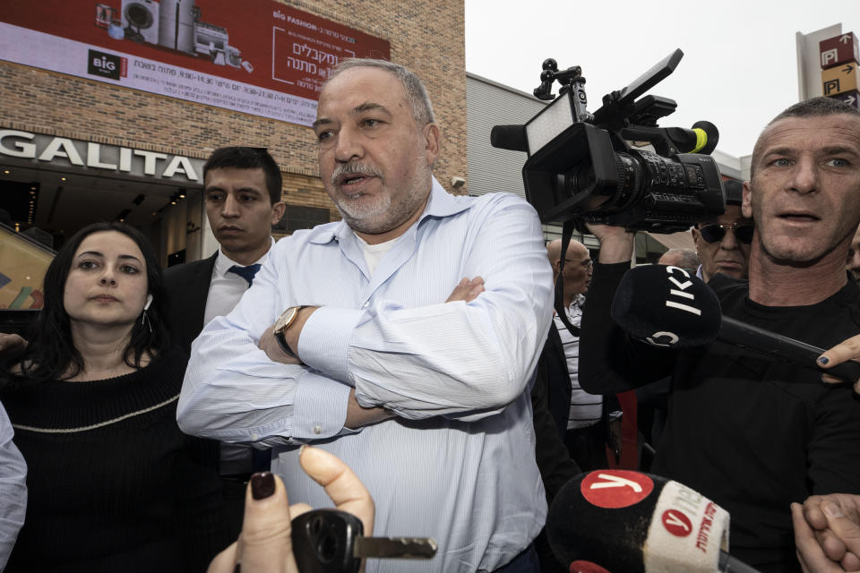 FILE - In this Feb. 14, 2020 file photo, Avigdor Lieberman, center, leader of the Yisrael Beiteinu, party, meets people during election campaign tour in a shopping mall in the Port city of Ashdod, Israel. Israel finds itself in a familiar place after a tumultuous election campaign, with Lieberman seemingly in control of the country’s fate. Opinion polls ahead of the March 2 vote show that neither Prime Minister Benjamin Netanyahu nor his challenger Benny Gantz will be able to form a coalition government without him. Lieberman remains cagey about his intentions, raising the possibility his brinkmanship could end up forcing yet another election. (AP Photo/Tsafrir Abayov, File)