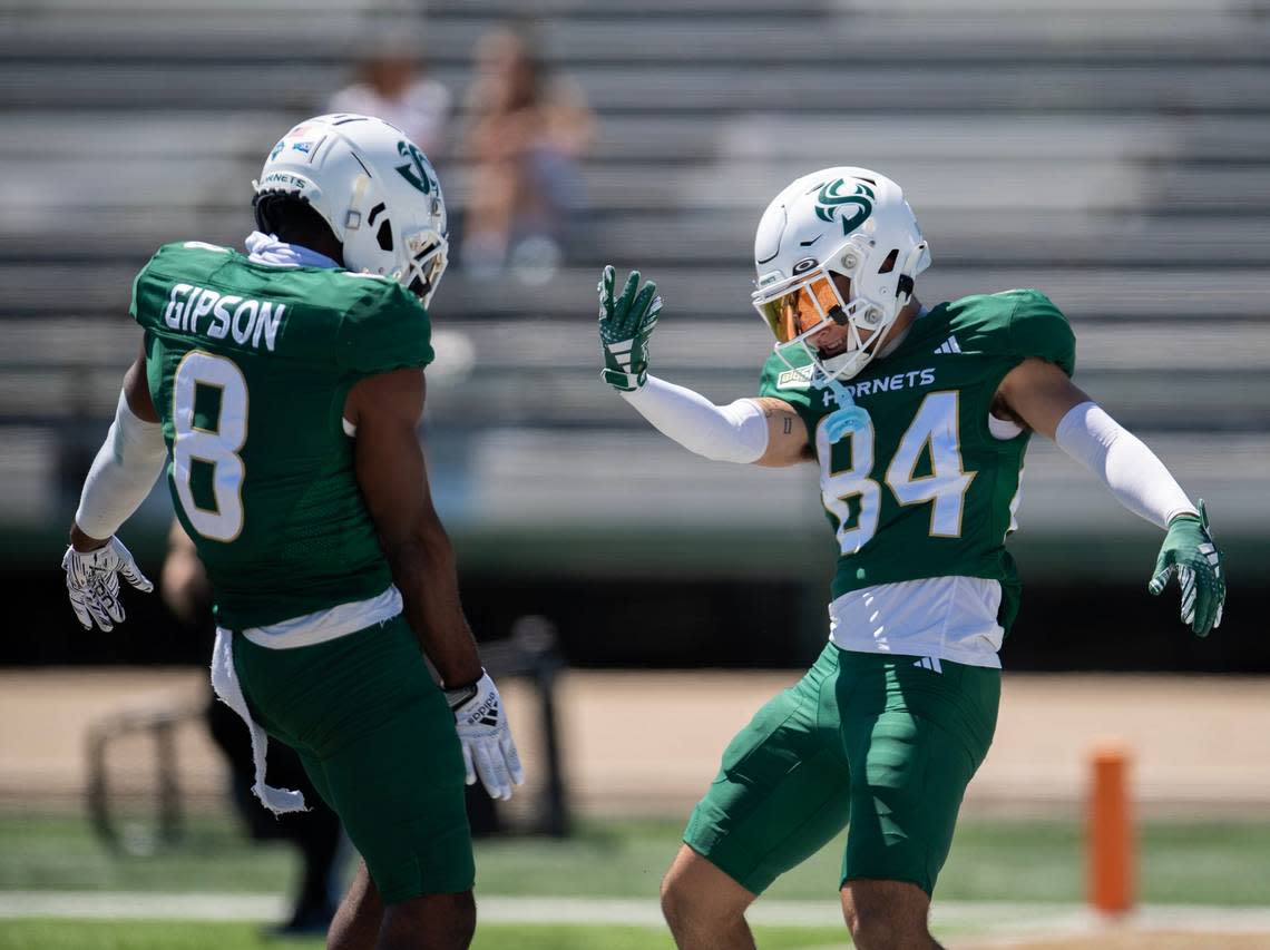 Sacramento State Hornets wide receiver Danny Scudero (84) celebrates with wide receiver Jared Gipson (8) following a touchdown catch during the annual Sacramento State spring football game on Saturday at Sacramento State.