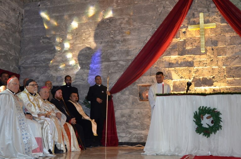 Iraqis clergymen attend a Christmas Eve mass at Saint Paul's church in the country's second city Mosul