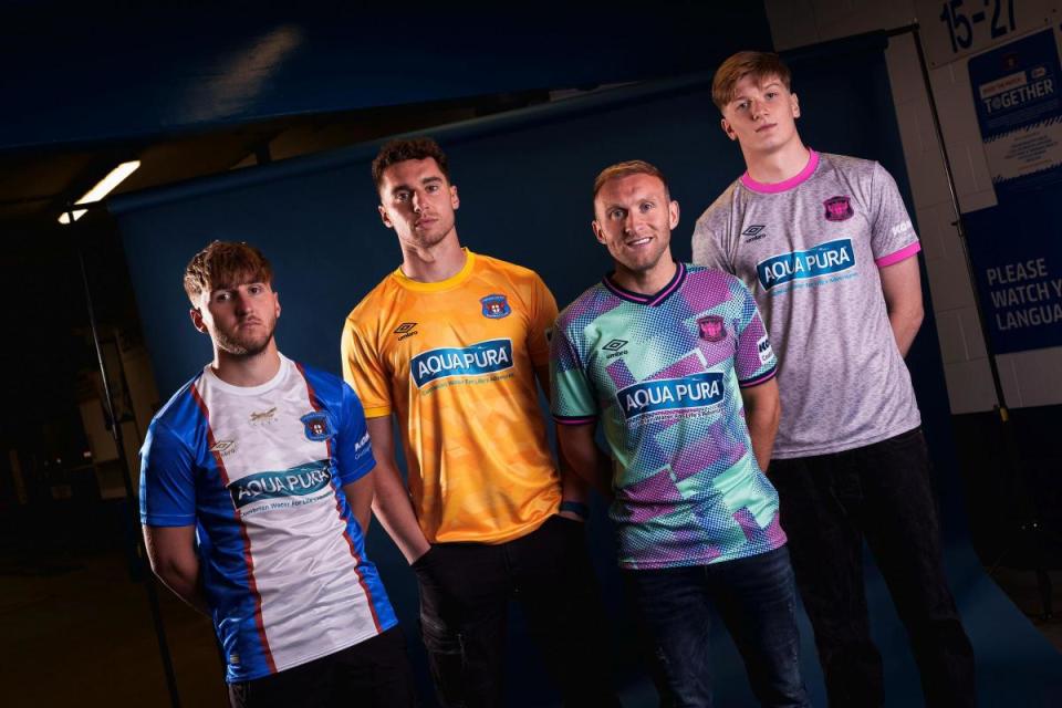 (left to right) United's home shirt, home goalkeeping top, away shirt and away keeper top are modelled by Dan Butterworth, Harry Lewis, Dylan McGeouch and Gabe Breeze <i>(Image: Carlisle United)</i>