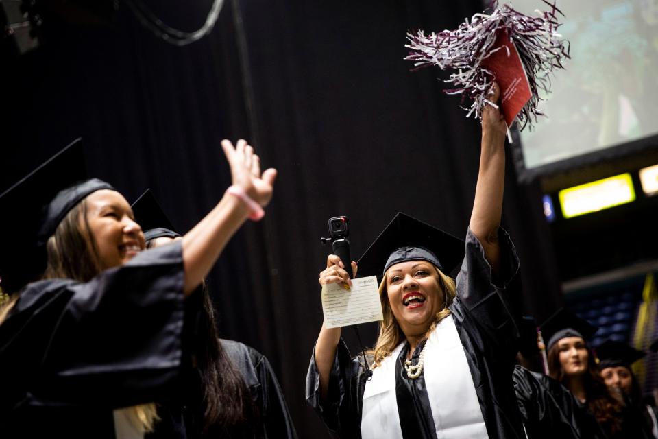 Graduates wave to their friends and families during the commencement for Hodges University at Hertz Arena in Estero on Sunday, June 9, 2019, when 480 students graduated.