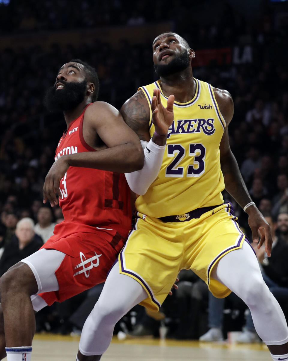 Los Angeles Lakers' LeBron James (23) vies for position under the basket next to Houston Rockets' James Harden during the first half of an NBA basketball game Thursday, Feb. 21, 2019, in Los Angeles. (AP Photo/Marcio Jose Sanchez)