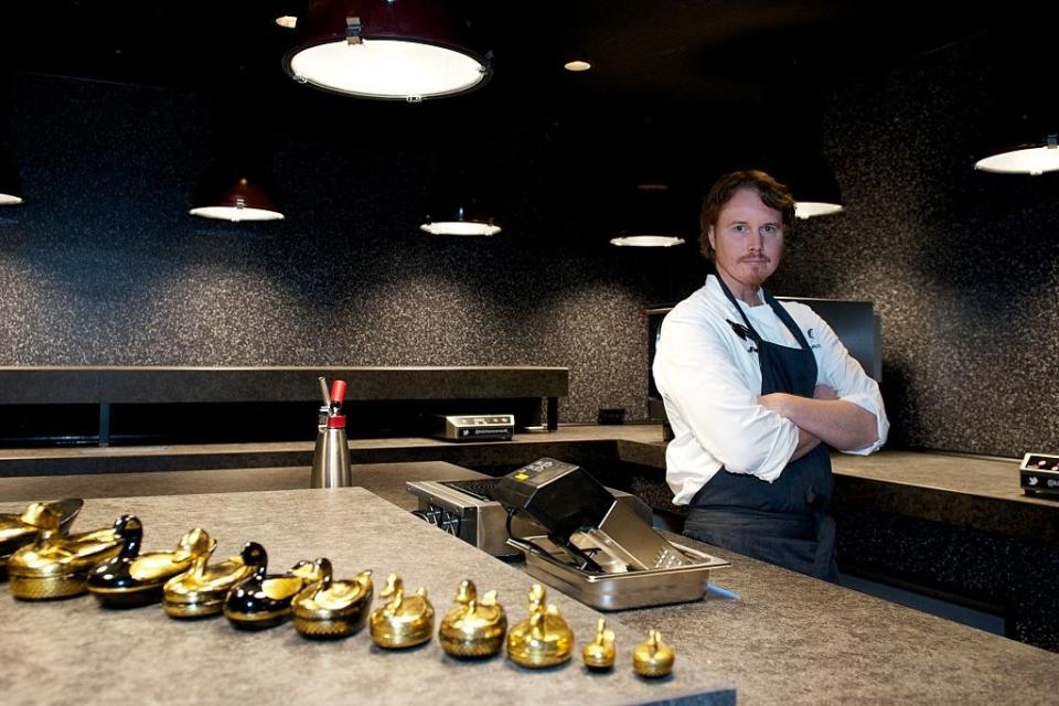 Achatz standing in a kitchen