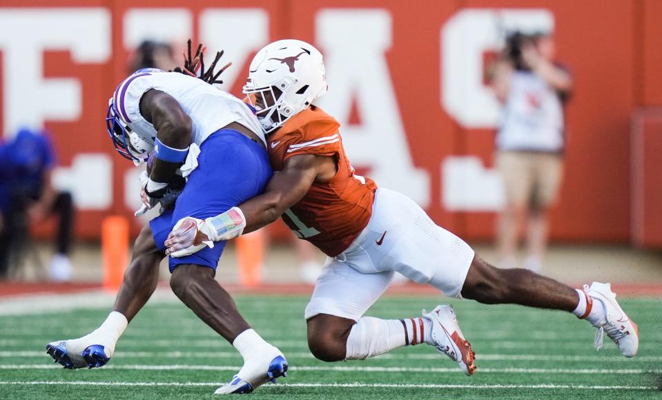 Texas safety Jalen Catalon tackles Kansas wide receiver Doug Emilien in the fourth quarter of the Longhorns' 40-14 win Sept. 30. Catalon was injured in Saturday's loss to Oklahoma, and his status for next week's game at Houston won't be known till at least next Monday.