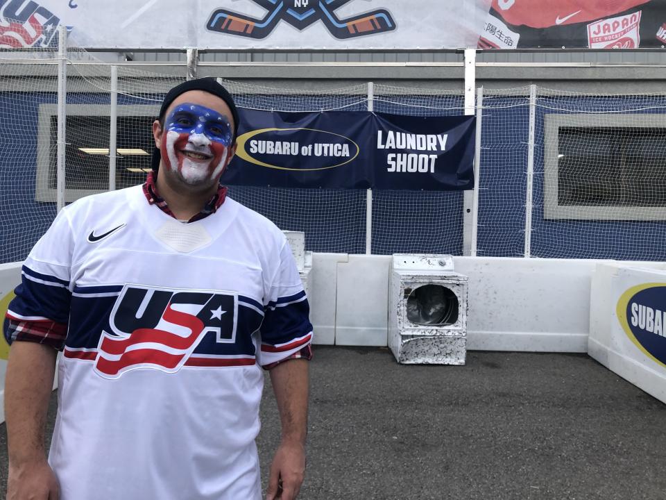Gaetano Morreale, of Utica, tried hitting a hockey puck into a dryer in the laundry shoot challenge at the Subaru World Championship Village before heading off to root for the USA in its game against Japan on April 11, 2024. Morreale threw himself into rooting for Finland and for Germany in previous games, complete with appropriate face paint.