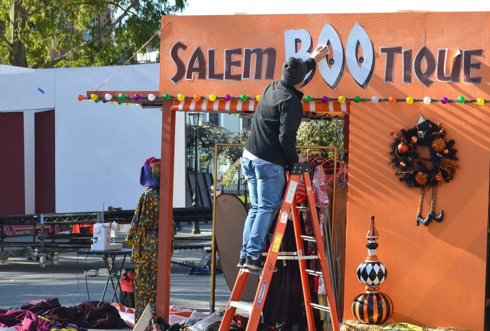 A member of the 'Hocus Pocus 2' film crew works on one of the booths set up on Washington Square in Newport in November 2021.