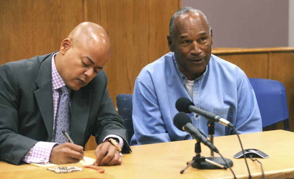 <p>Former NFL football star O.J. Simpson, right, reacts after learning he was granted parole at Lovelock Correctional Center in Lovelock, Nev., on Thursday, July 20, 2017. Simpson was convicted in 2008 of enlisting some men he barely knew, including two who had guns, to retrieve from two sports collectibles sellers some items that Simpson said were stolen from him a decade earlier. (Jason Bean/The Reno Gazette-Journal via AP, Pool) </p>