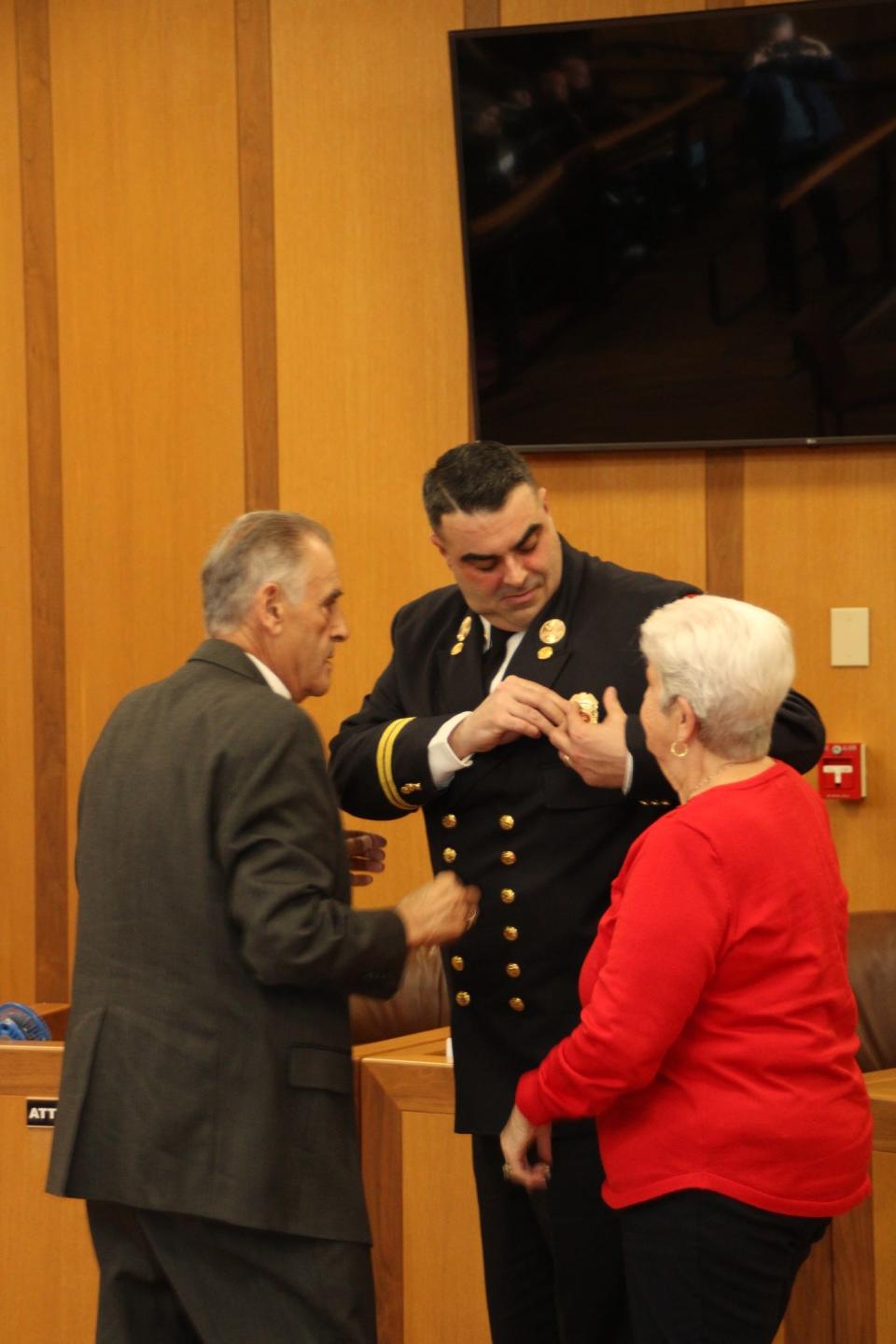 New Deputy Chief Neil Furtado is pinned by his parents at the ceremony on Thursday.