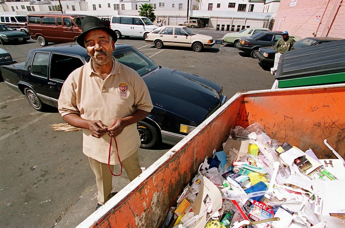 Willie Fulgear poses by the bins where he found the Oscars (Getty)