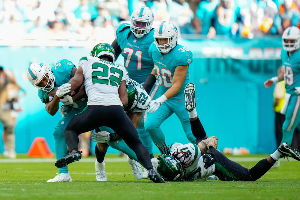 Jan 8, 2023; Miami Gardens, Florida, USA; New York Jets safety Tony Adams (22) tackles Miami Dolphins running back Raheem Mostert (31) during the second half at Hard Rock Stadium. Mandatory Credit: Rich Storry-USA TODAY Sports