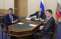 Russian President Vladimir Putin, center, Deputy Prime Minister of Russia Dmitry Kozak, left, and Russian Minister of Energy Alexander Novak attend a joint video conference with Chinese President Xi Jinping during inaugurating the Power of Siberia pipeline in the Bocharov Ruchei residence in the Black Sea resort of Sochi, Russia, Monday, Dec. 2, 2019. China and Russia launched Monday a more than 6,000 kilometer-long gas pipeline in one realization of the countries' long-planned energy partnerships. (Mikhail Klimentyev, Sputnik, Kremlin Pool Photo via AP)