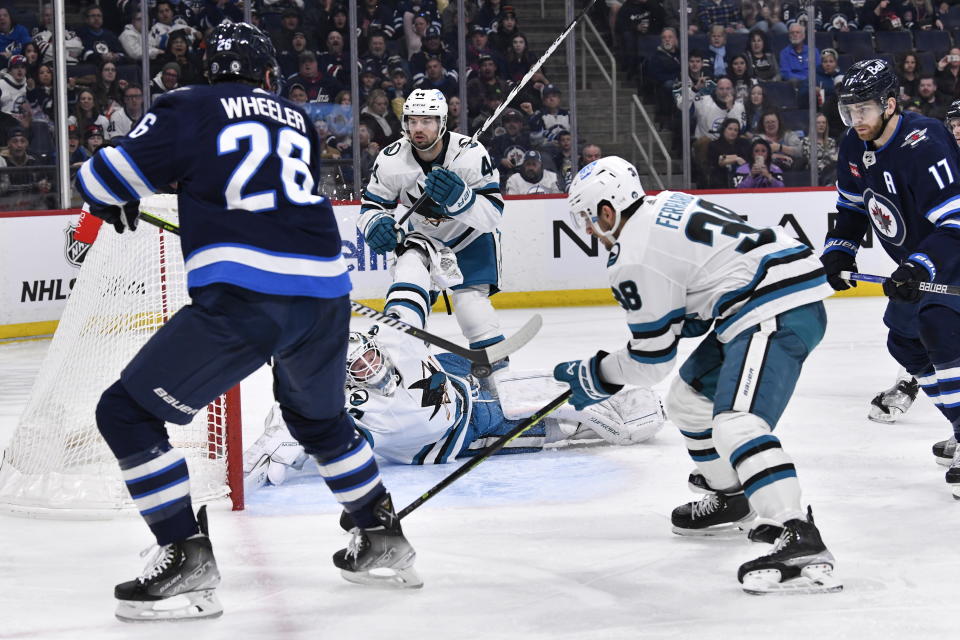 San Jose Sharks goaltender James Reimer blocks the net as Winnipeg Jets' Blake Wheeler prepares to take a shot during the second period of an NHL hockey game, in Winnipeg, Manitoba, on Monday March 6, 2023. (Fred Greenslade/The Canadian Press via AP)