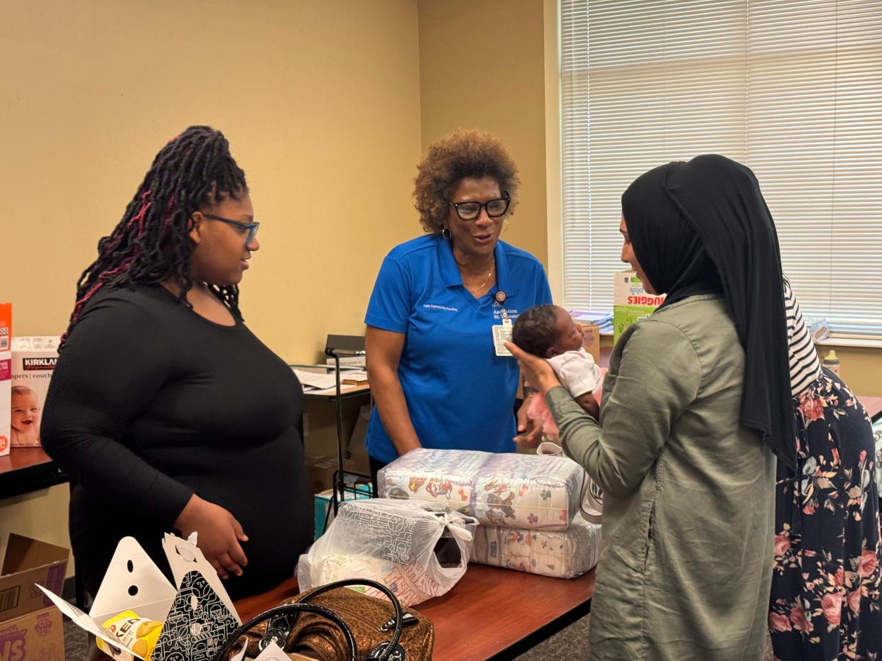 Willie Roberts, Ascension St. Vincent’s Community Outreach-Faith nursing manager in Jacksonville, bonds with one of the babies and new mothers in the Brighter Beginnings class she leads.