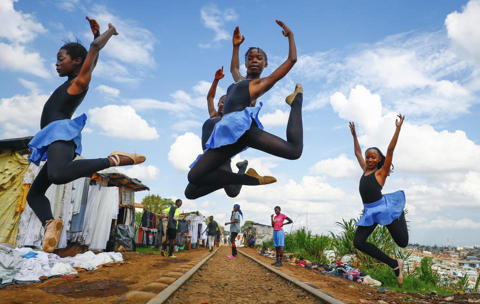 Young girls practice by the Kenya - Uganda railway line prior to the start of a Christmas ballet, in Kibera, one of the busiest neighborhoods of Kenya's capital, Nairobi, Friday, Dec. 15, 2023. The ballet project is run by Project Elimu, a community-driven nonprofit that offers after-school arts education and a safe space to children in Kibera. (AP Photo/Brian Inganga)