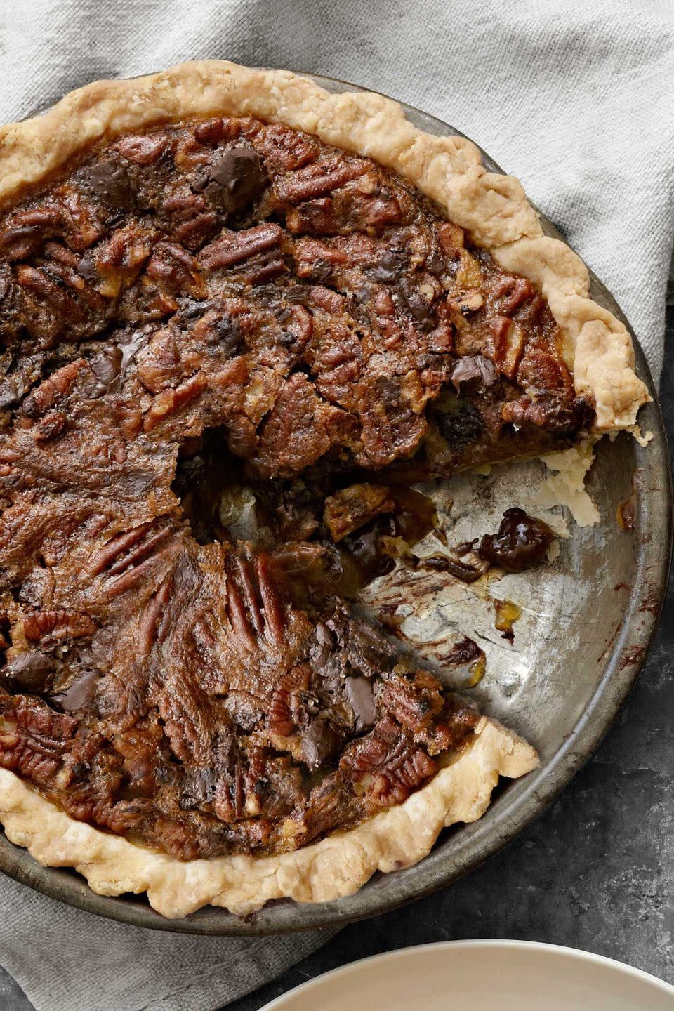 chocolate pecan pie in a metal pie tin